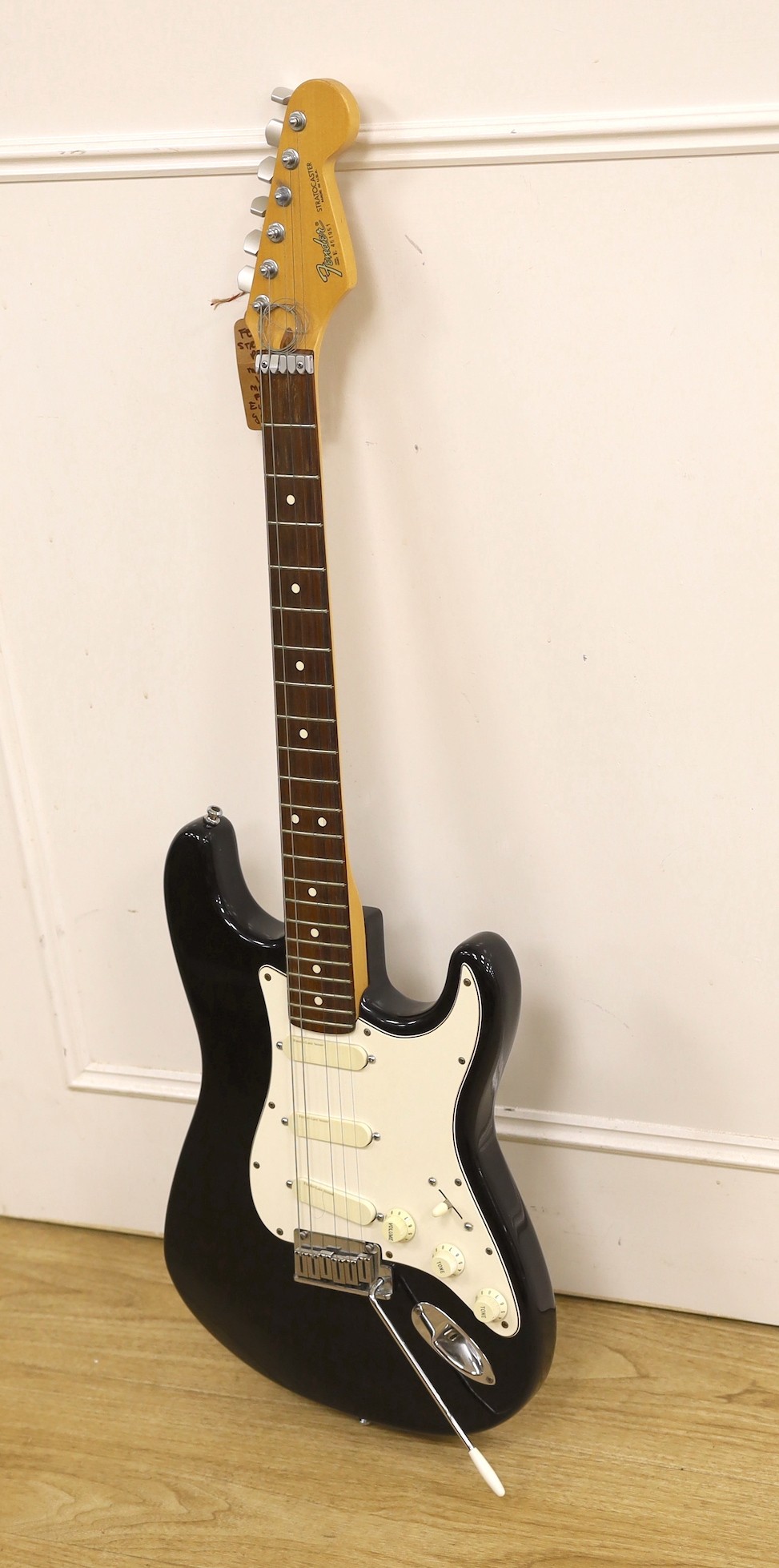 A 1980’s Fender Stratocaster, U.S.A. Serial No. E451951, lace sensor pickups with hard flight case, 98cms high.